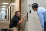 Access control technician working at a manufacturing entrance